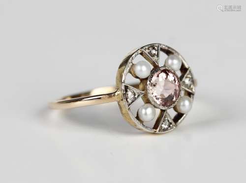 A gold ring, collet set with the circular cut pink tourmalin...