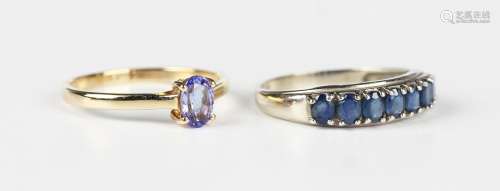 A white gold and sapphire half-hoop ring, claw set with a ro...