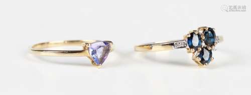 A 9ct gold ring, mounted with three oval cut sapphires, othe...