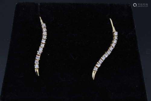 Pair of diamond earrings, each with a serpentine line of ele...
