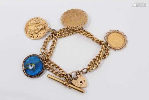 Charm bracelet with half sovereign and two gold charms on ye...