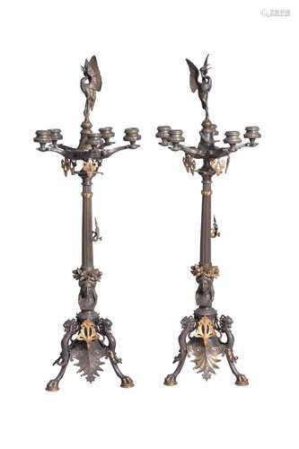 A pair of French patinated and gilt bronze five light candel...