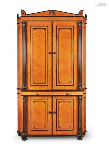 Y An Amboyna and ebonised cabinet in Regency style