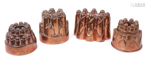 Four antique copper jelly moulds, including a castelated mou...