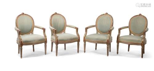 A set of four French grey painted and parcel gilt fauteuils