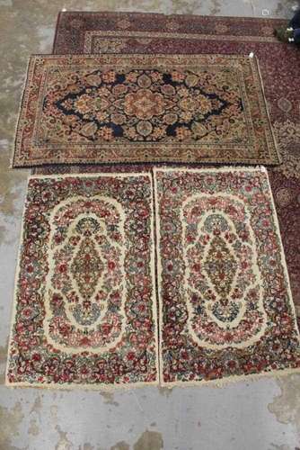 Pair of Eastern rugs together with one other