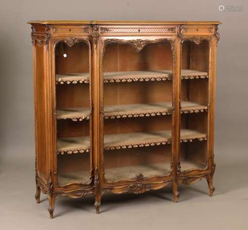 An early 20th century French carved walnut breakfront displa...
