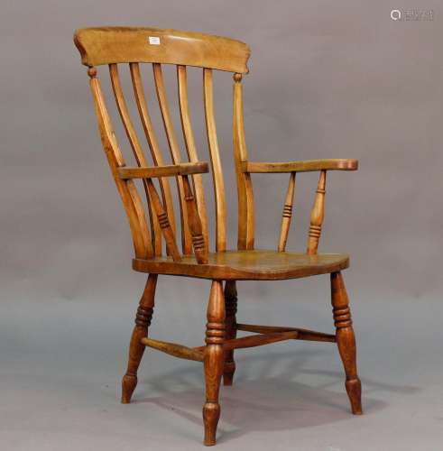 A 19th century ash and elm Windsor armchair with comb back a...