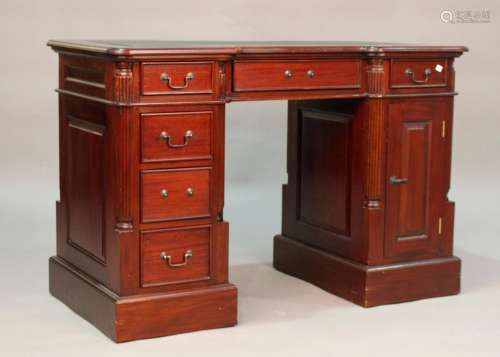 A late 20th century reproduction mahogany twin pedestal desk...
