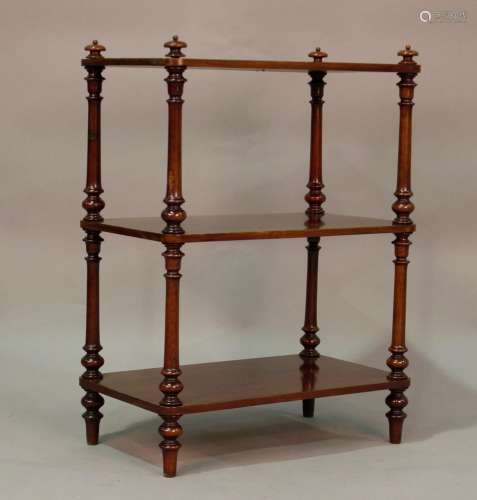 A Victorian mahogany three-tier whatnot on turned supports, ...