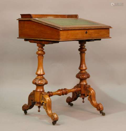 A late Victorian walnut Davenport, raised on carved cabriole...