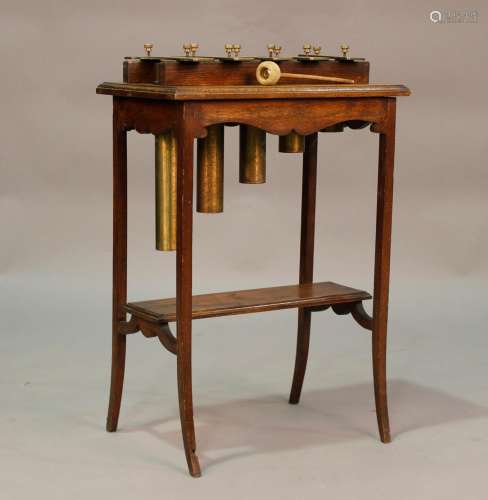 An early 20th century oak framed glockenspiel, raised on spl...