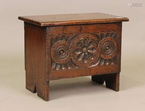 A 20th century Tudor style carved oak coffer, the front carv...