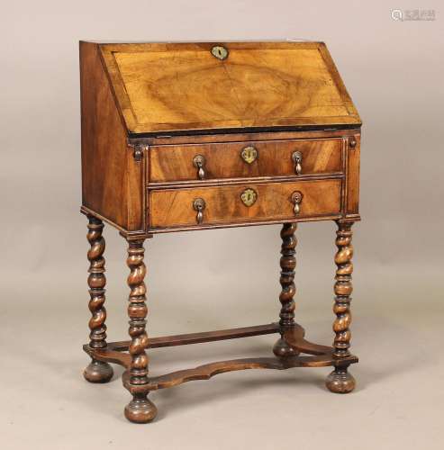 An early 20th century Queen Anne style walnut bureau, the fa...