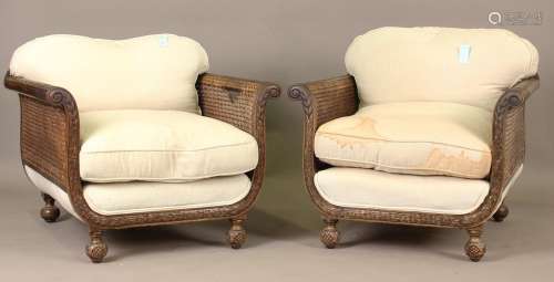 A pair of George V mahogany framed bergère armchairs, the fr...
