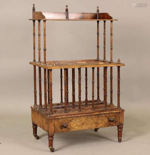 A late Victorian burr walnut Canterbury whatnot, on turned s...