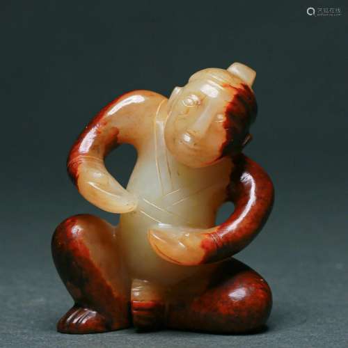 A Carved White and Russet Jade Figure