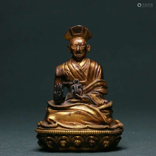 A Tibetan Bronze-gilt Seated Master