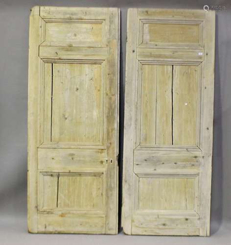 A large pair of 19th century pine two-section panelled doors...