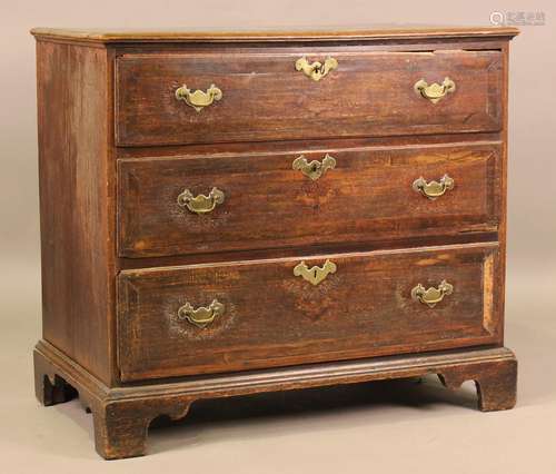 A George III provincial oak chest of three long drawers, on ...