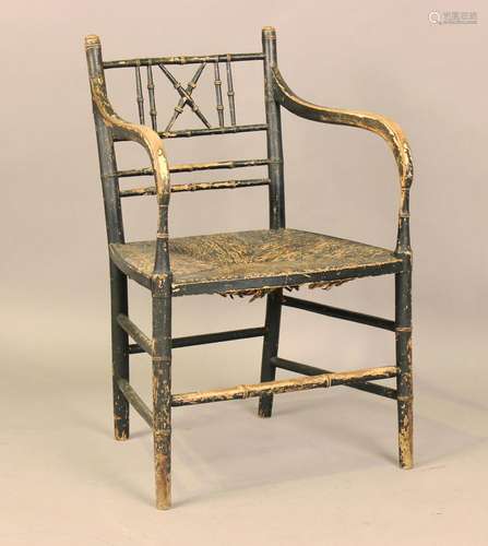 A Regency ebonized elbow chair of turned faux bamboo form, i...