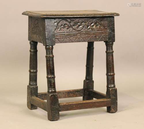 A 17th century and later oak joint stool with carved frieze ...