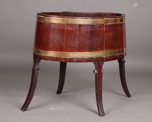 A George III mahogany coopered oval wine cooler, the brass b...