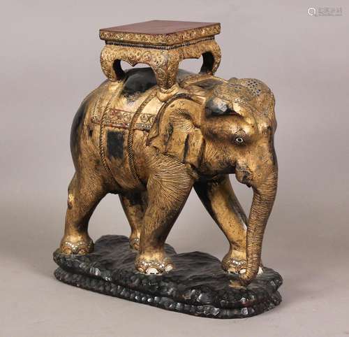 A 20th century Indian carved wooden model of an elephant wea...