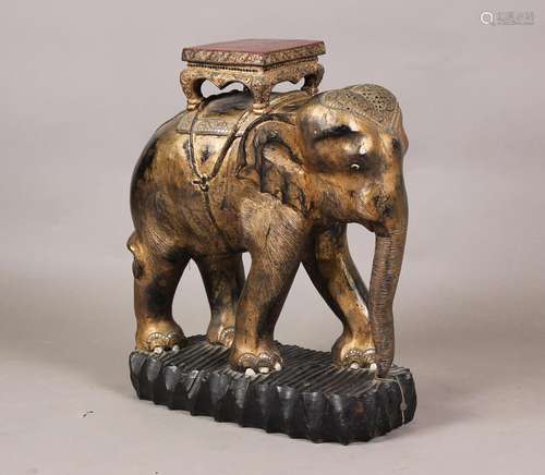 A 20th century Indian carved wooden model of an elephant wea...