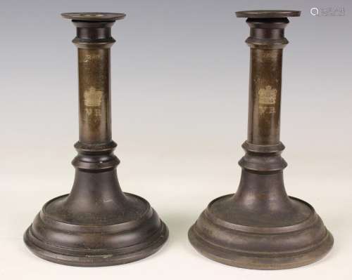 A pair of Victorian bronze candlesticks of turned form, each...
