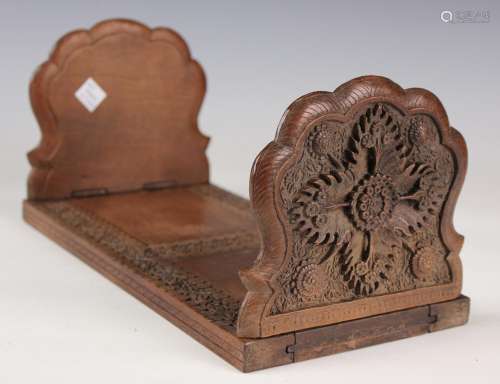 A South-east Asian hardwood extending book rack with ornate ...