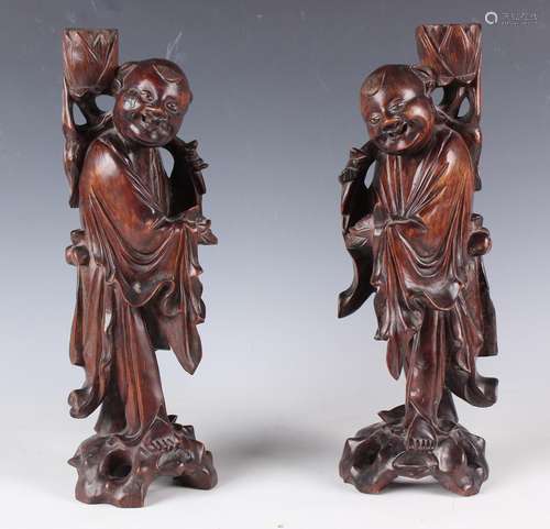 A pair of Chinese carved hardwood figures of standing sages,...