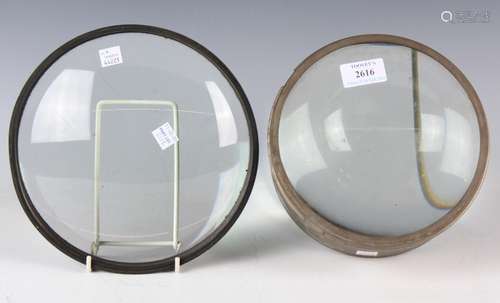 A large glass optical lens, housed in a circular metal surro...