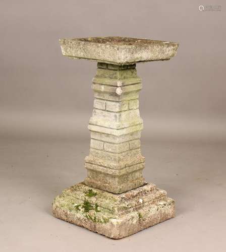 A 20th century cast composition stone birdbath on a brick ef...