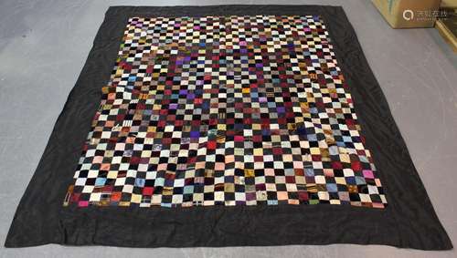 A 20th century patchwork bedcover, worked from silk, velvet ...