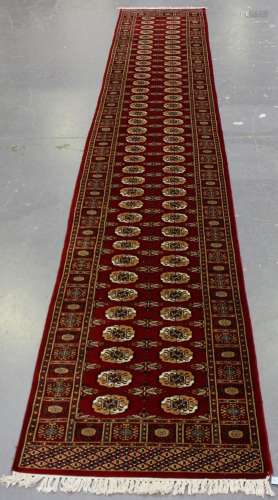 A Pakistan bokhara style runner, late 20th century, the clar...
