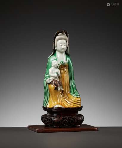 A BISCUIT PORCELAIN FIGURE OF GUANYIN WITH CHILD, KANGXI PER...