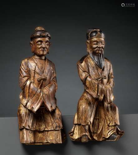 A PAIR OF GILT-LACQUERED HARDWOOD FIGURES OF DAOIST IMMORTAL...
