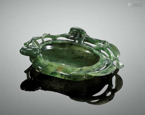 A SPINACH-GREEN JADE ‘BEETLE AND LOTUS’ WASHER, QING DYNASTY