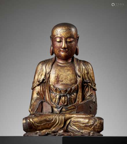 A GILT-LACQUERED WOOD FIGURE OF A LUOHAN, MING DYNASTY