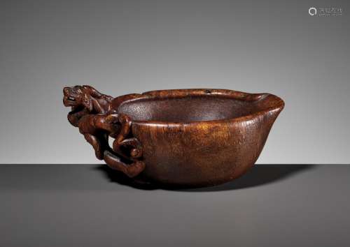 A RARE RHINOCEROS HORN ‘CHILONG’ POURING VESSEL, YI, LATE MI...