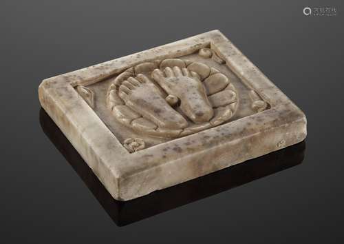 A CARVED MARBLE PLAQUE DEPICTING THE FEET OF VISHNU