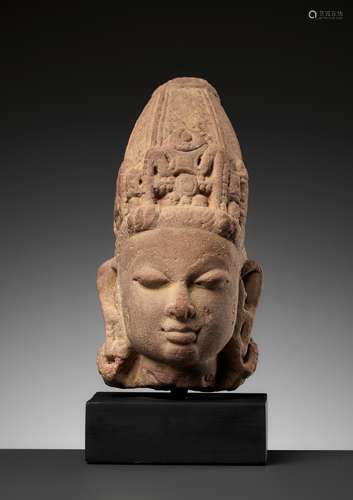 A RED SANDSTONE HEAD OF VISHNU WITH A MITER CROWN