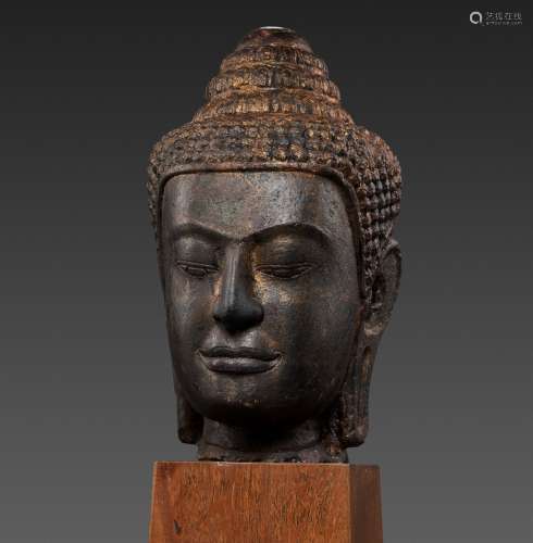 A LARGE SANDSTONE HEAD OF BUDDHA, POST-ANGKOR PERIOD