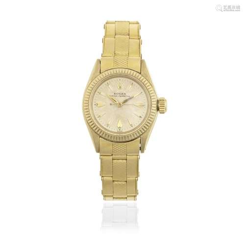 Rolex. A lady's 9K gold automatic watch with 18K gold br...