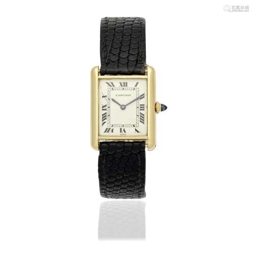 Cartier. An 18K gold manual wind rectangular wristwatch Tank...