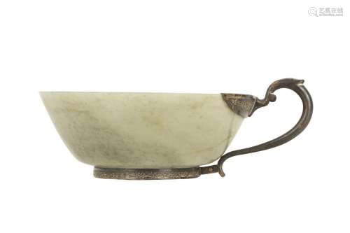 A PALE CELADON JADE CUP WITH A WHITE METAL HANDLE.