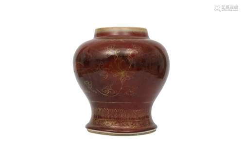 A CHINESE GILT-DECORATED COPPER RED-GLAZED VASE.