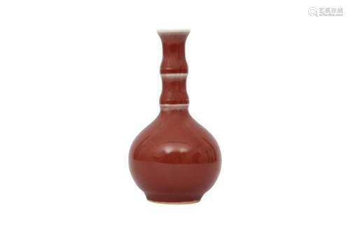 A SMALL CHINESE SANG-DE-BOEUF BOTTLE VASE.