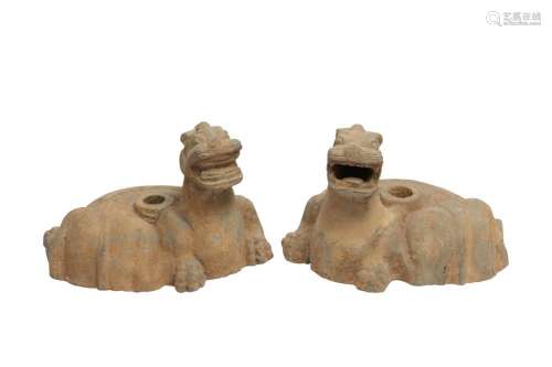 A PAIR OF CHINESE POTTERY 'MYTHICAL BEASTS' CANDLEST...